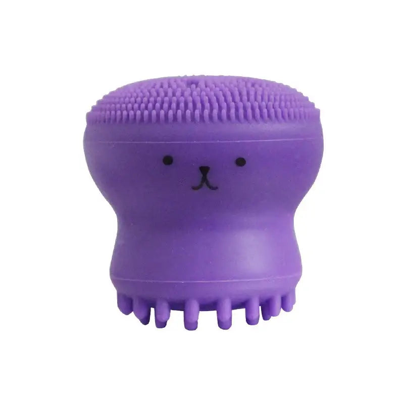 Escova de limpeza facial de silicone roxa em forma de polvo com um desenho de rosto bonito.