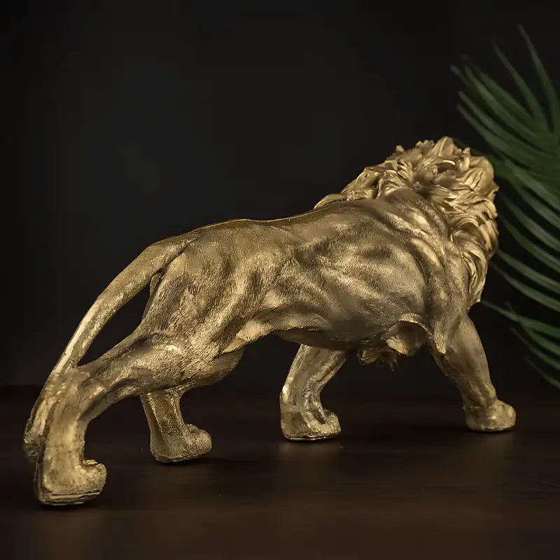 Escultura de leão dourado com uma postura majestosa e juba esvoaçante.